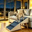 Beige foldable pet ramp beside a sofa with a small dog