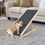 Adjustable wooden dog ramp with non-slip carpet beside a couch