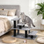 Gray modular pet stairs beside a bed with a cat