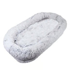 Oversized light gray faux fur human dog bed