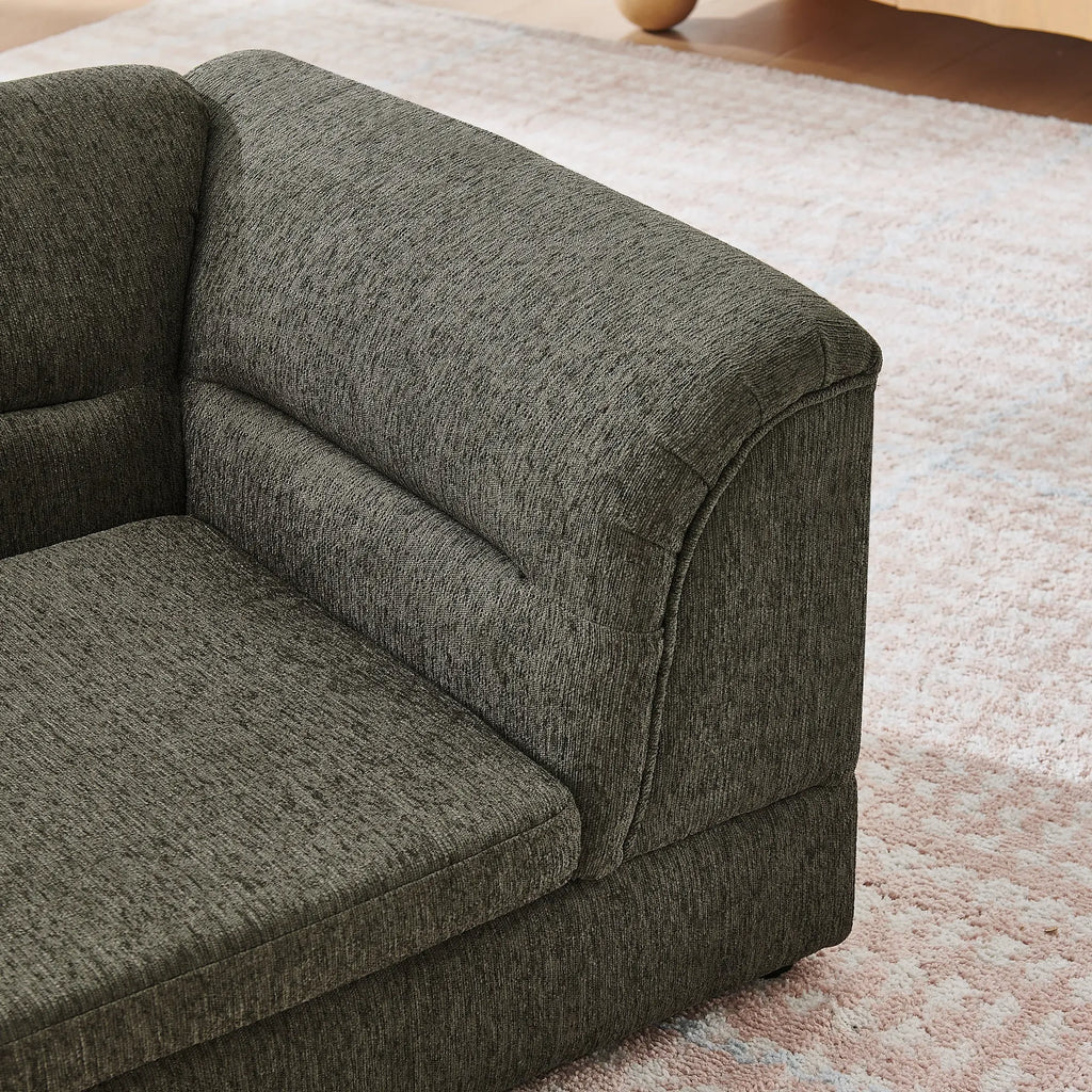 Curved padded armrest on dark gray dog sofa