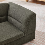 Curved padded armrest on dark gray dog sofa