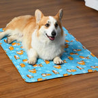 Corgi resting on a blue patterned cooling mat
