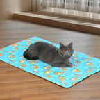 Cat lying on a blue patterned cooling mat