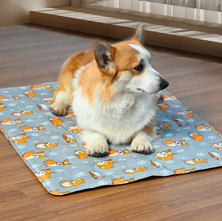 Corgi sitting on a gray patterned cooling mat