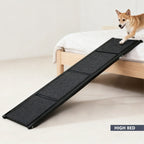Dog using a foldable ramp to access a high bed