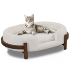 Beige oval dog bed with fabric cushion and solid wood frame — main product view