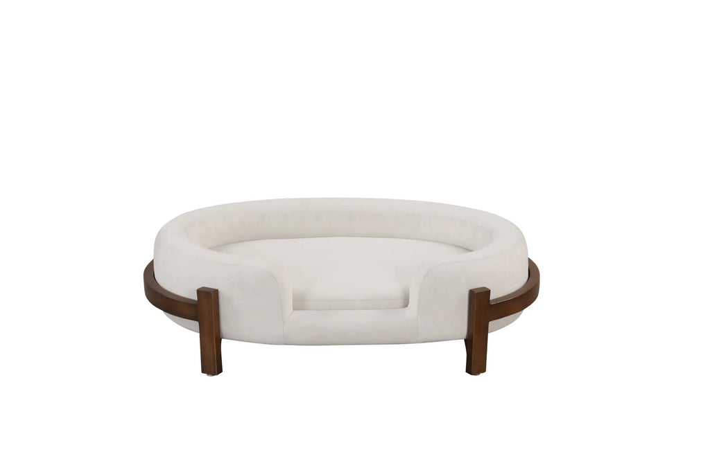 Beige oval dog bed with fabric cushion and solid wood frame — lifestyle view