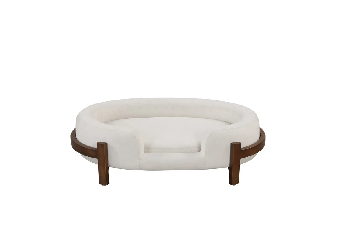 Beige oval dog bed with fabric cushion and solid wood frame — lifestyle view