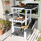 Gray and white four-tier outdoor cat house with ramps and waterproof roof — lifestyle view