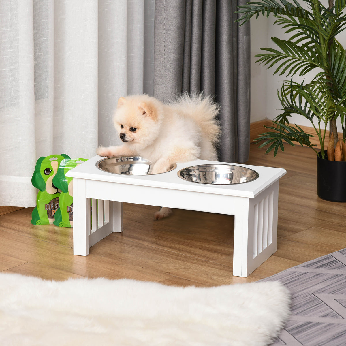 Small dog using the white elevated double-bowl feeding station Main image