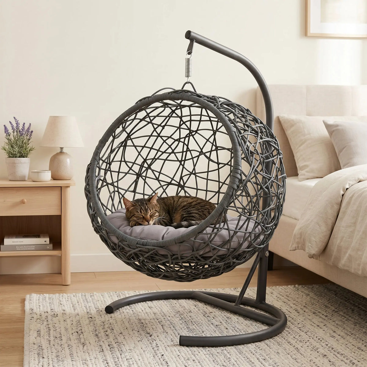 Gray rattan-style hanging cat swing bed with cushion and stand — lifestyle view