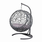 Gray rattan-style hanging cat swing bed with cushion and stand — usage example