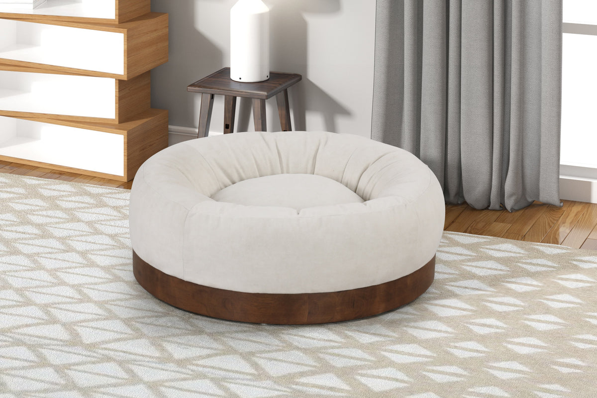 Round plush pet bed beside a bedroom chair