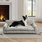Beige elevated dog sofa bed with a large black and white dog