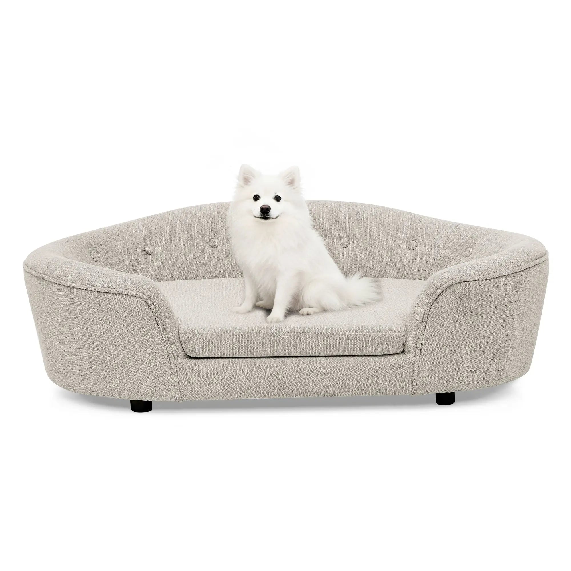 Beige oval dog sofa bed with a small white dog