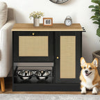 Black dog feeding cabinet with rattan-style doors beside a corgi in a living room