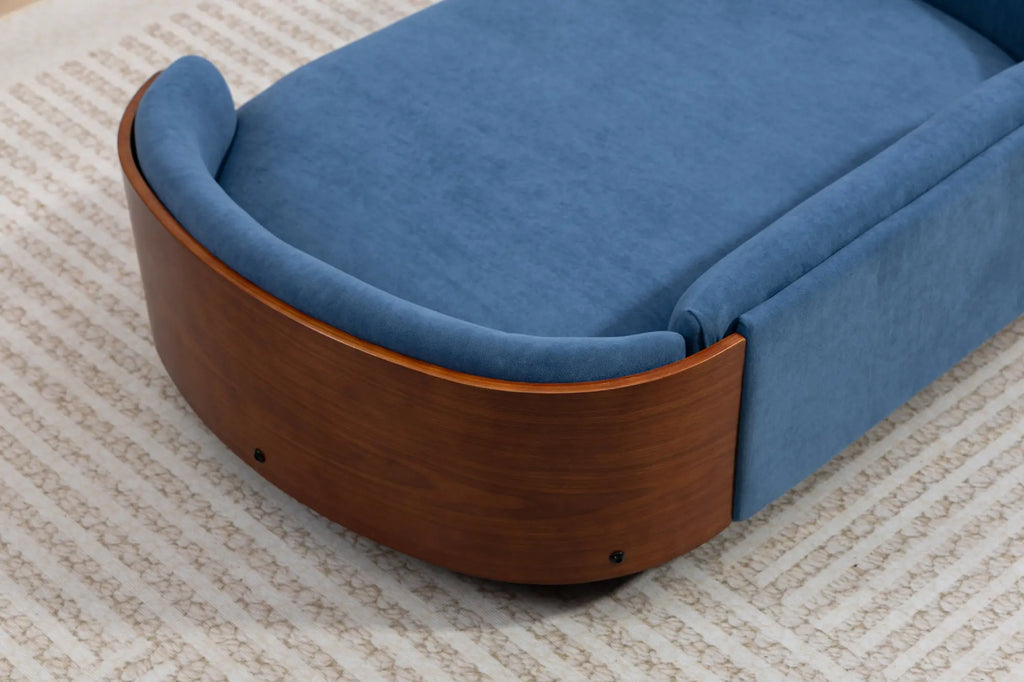 Curved walnut shell on a blue velvet dog sofa