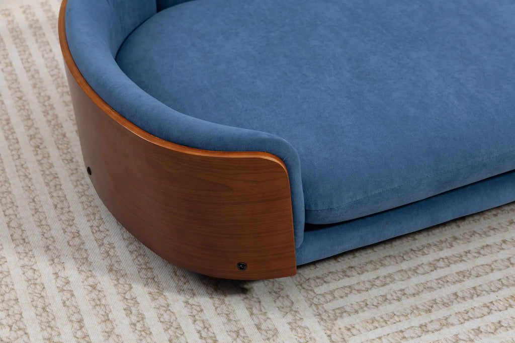 Walnut arm detail on a blue velvet dog sofa
