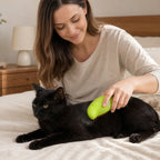 Green mango-shaped cat mist brush used on a black cat