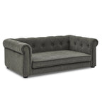 Dark gray tufted dog sofa bed with rolled arms, angled front view