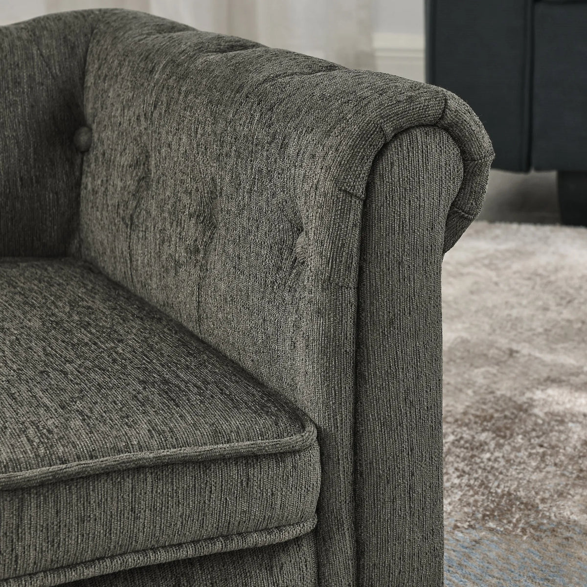 Close-up of the upholstered rolled arm and seat cushion