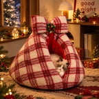 Cat resting in red plaid cave bed