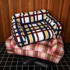 Multicolor pet sofa resting on an empty pink sofa