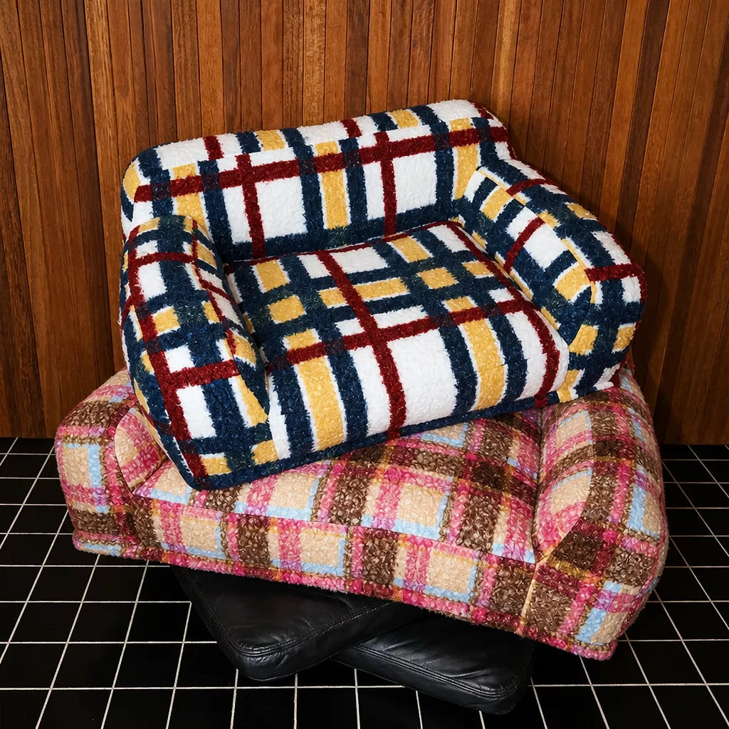Multicolor pet sofa resting on an empty pink sofa