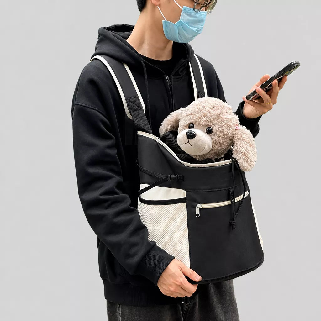 Small dog carried at the front in the black mesh backpack