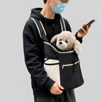 Small dog carried at the front in the black mesh backpack
