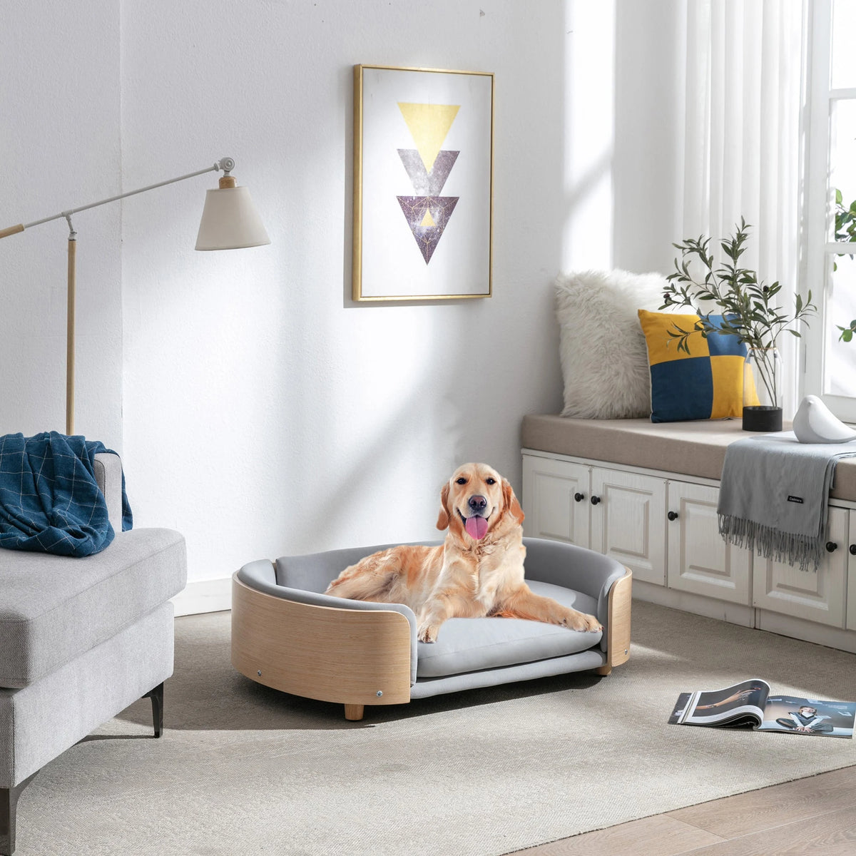 Small dog resting on gray pet sofa