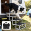 Black foldable four-step dog stairs beside an RV