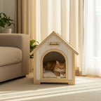 Cat resting inside a wooden indoor pet house by a sofa