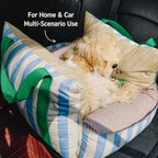 Dog resting in striped pet car bed