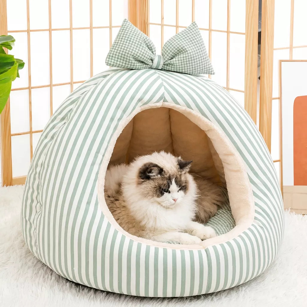 Green striped pet cave bed with bow and cat