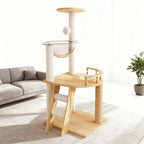 Natural wood cat tower beside a sofa