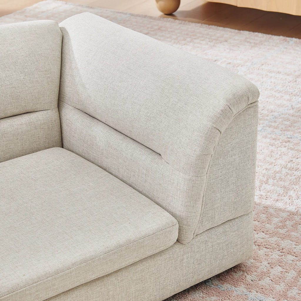 Curved bolster arm detail on a beige dog sofa