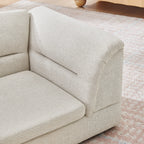 Curved bolster arm detail on a beige dog sofa