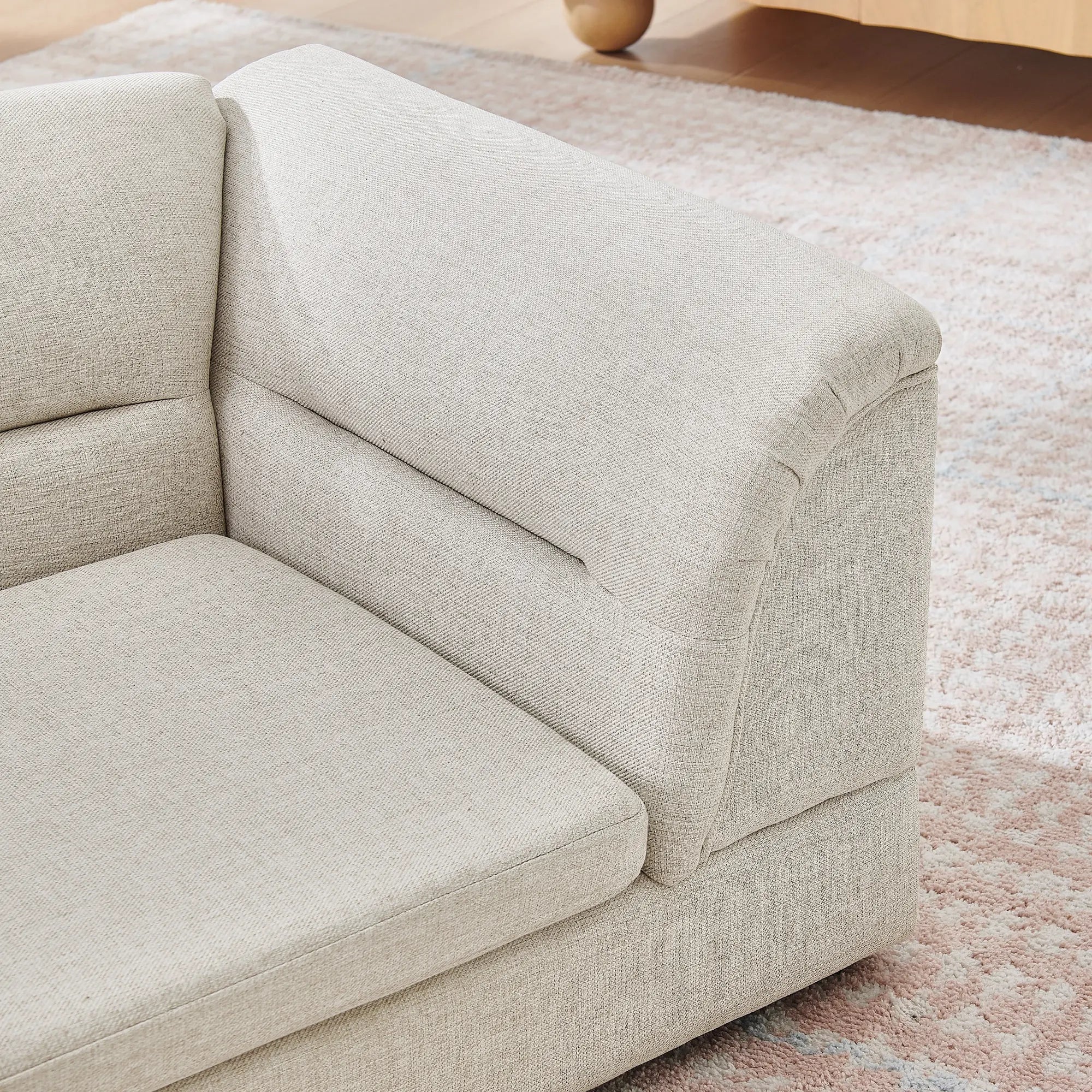 Curved bolster arm detail on a beige dog sofa
