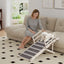 PawHut wooden dog ramp with upper guardrails beside a sofa, with a small white dog