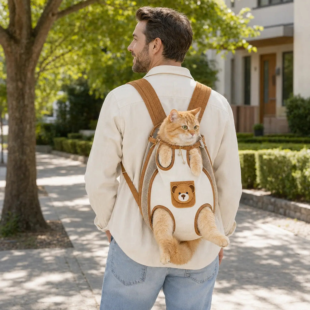 Beige and brown pet carrier backpack worn on the back with an orange cat
