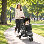 Black folding pet stroller with a small dog on a park path