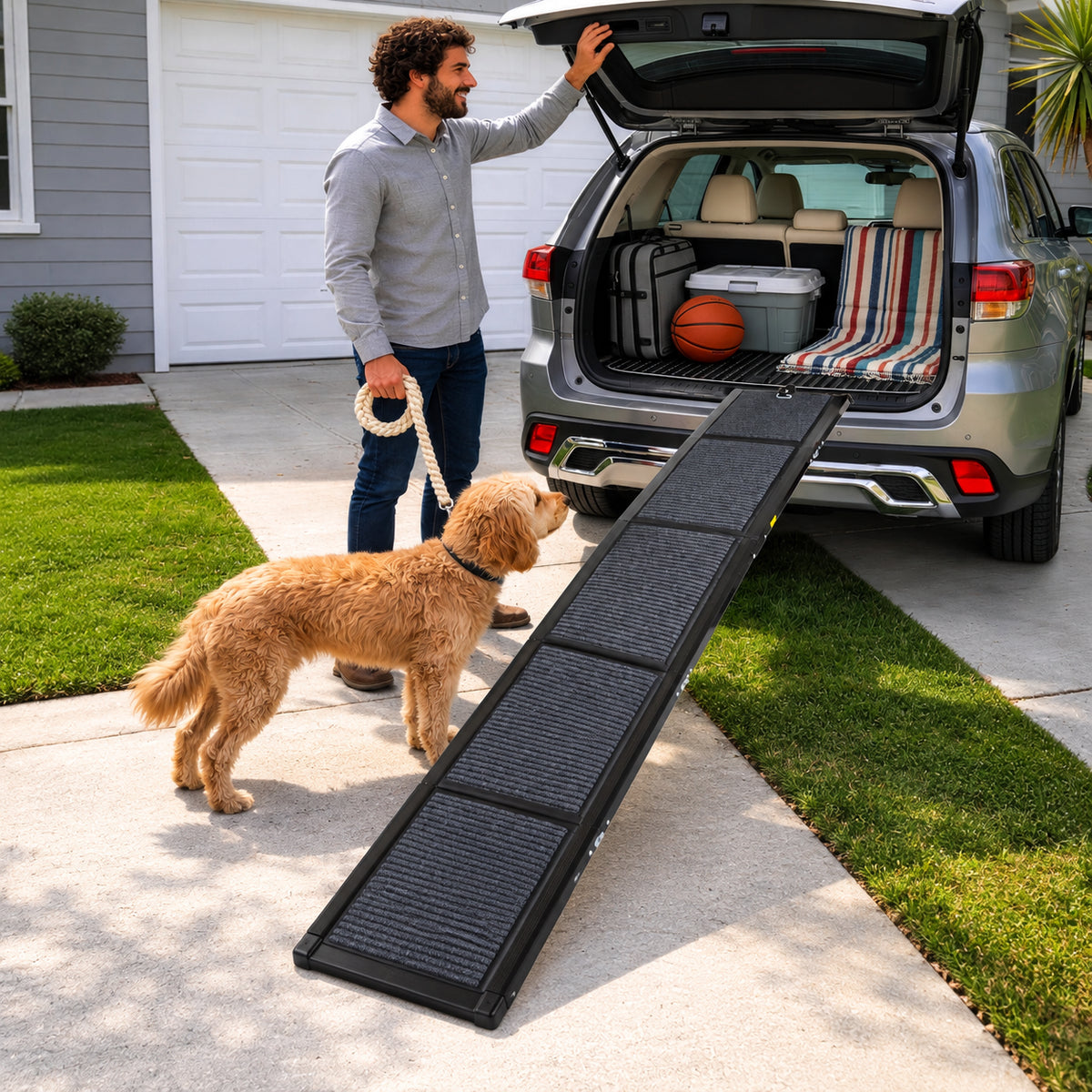 Four-fold dog car ramp leading into an SUV on a driveway