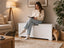 White hidden cat litter box cabinet used as a living room bench
